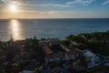 Aerial view of houses situated near the coast at sunset in Roatan Honduras