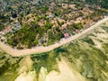 Aerial view of a huge coral reef table forming a fringing reef around a tropical island