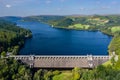 Aerial view of a huge lake surrounded by rural farmland and forest.