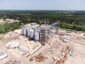 Aerial view of huge modern grain elevator. Food storage, building in progress. Silo farm. Agribusiness development