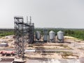 Aerial view of huge modern grain elevator. Food storage, building in progress. Silo farm. Agribusiness development