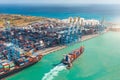 Aerial view of a huge port with containers and cargo ships entering the port for loading and unloading Royalty Free Stock Photo