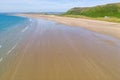 Aerial view of a hugem wide sandy beach at low tide Rhossili, Wales