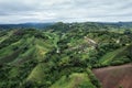 Aerial view of hut resort on hillside among the mountain in tropical rainforest on rainy day