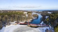 Aerial view of hydroelectric power plant in the river surrounded by dense trees in winter Royalty Free Stock Photo