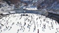 Aerial view of ice skating peolpe outdoor, ice rink Medeo