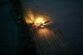 Aerial view of an illuminated combine harvestor machinery on a rural field in Ukraine