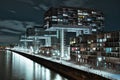 Aerial view of illuminated crane houses by the canal at the Zollhafen in Cologne, Germany at night