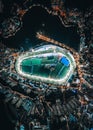 Aerial view of the illuminated Happy Valley Racecourse in Hong Kong at night.