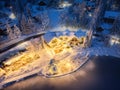 Aerial view of illuminated houses in snowy village at night Royalty Free Stock Photo