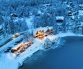 Aerial view of illuminated houses in snowy village at night