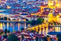 Aerial view of illuminated Prague with Charles Bridge during twilight sunset in Czech Republic. View from Petrin hill