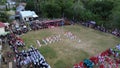 Aerial view of Indonesian flag lowering ceremony witnessed by villagers. Indonesia Independence Day