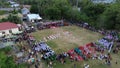 Aerial view of Indonesian flag lowering ceremony witnessed by villagers. Indonesia Independence Day