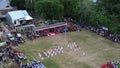 Aerial view of Indonesian flag lowering ceremony witnessed by villagers. Indonesia Independence Day