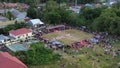 Aerial view of Indonesian flag lowering ceremony witnessed by villagers. Indonesia Independence Day