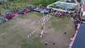 Aerial view of Indonesian flag lowering ceremony witnessed by villagers. Indonesia Independence Day