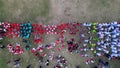 Aerial view of Indonesian flag lowering ceremony witnessed by villagers. Indonesia Independence Day
