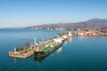 Aerial view industrial cargo and oil port with ship tanker vessel loading in gas and oil terminal station refinery Royalty Free Stock Photo