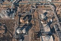 Aerial view of industrial factory or plant buildings with steel storage construction tanks and pipes