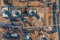 Aerial view of industrial factory or plant buildings with steel storage construction tanks and pipes