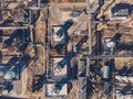 Aerial view of industrial factory or plant buildings with steel storage construction tanks and pipes, oil refinery concept