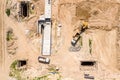 Aerial view of industrial machines preparing ground for road construction