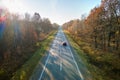 Aerial view of intercity road with blurred fast driving car at sunset. Top view from drone of highway traffic in evening