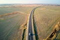 Aerial view of intercity road with blurred fast driving car at sunset. Top view from drone of highway traffic in evening