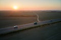 Aerial view of intercity road with fast driving cars at sunset. Top view from drone of highway traffic in evening Royalty Free Stock Photo