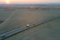 Aerial view of intercity road with fast driving cars at sunset. Top view from drone of highway traffic in evening Royalty Free Stock Photo