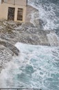 Storm on the croatian beach with waves crushing on cliffs.