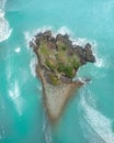 Aerial view of an Island with rocks, trees and waves crashing aorund Royalty Free Stock Photo