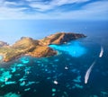 Aerial view of island, sea bay with clear azure water, boats