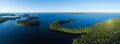 Aerial view of of islands on a blue lake Paijanne. Blue lake, islands and green forest from above on a sunny summer evening.