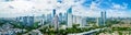 Aerial View of Jakarta Downtown Skyline with High-Rise Buildings With White Clouds and Blue Sky, Indonesia, Asia