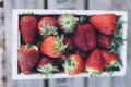 Aerial view of juicy strawberries in a wooden box