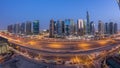 Aerial view of Jumeirah lakes towers skyscrapers day to night with traffic on sheikh zayed road. Royalty Free Stock Photo