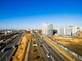 Aerial view at junctions of city highway. Vehicles drive on roads. Russia