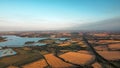 view of fields and small town rutland water in england at sunset in summer Royalty Free Stock Photo
