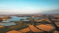 view of fields and small town rutland water in england at sunset in summer Royalty Free Stock Photo
