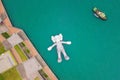 Aerial view of KAWS companion, giant sculpture floating on water. Figure in Victoria Harbour, Hong Kong. Republic of China