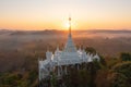 Aerial view of Khao Na Nai pagoda stupa. Luang Dharma Temple Park with green mountain hills and forest trees, Surat Thani,
