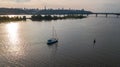 Aerial view of Kiev city skyline on sunset, yacht sailing in Dnieper river from above, Kyiv Royalty Free Stock Photo