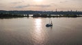 Aerial view of Kiev city skyline on sunset, yacht sailing in Dnieper river from above, Kyiv Royalty Free Stock Photo