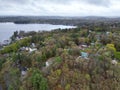 Aerial view of Lake Attitash and a town near a shoreline surrounded by colorful trees in autumn Royalty Free Stock Photo