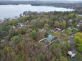 Aerial view of lake Attitash and a town near a shoreline surrounded by colorful trees in autumn Royalty Free Stock Photo