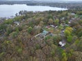 Aerial view of lake Attitash and a town near a shoreline surrounded by colorful trees in autumn Royalty Free Stock Photo