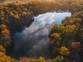 Aerial view of lake in beautiful autumn forest. Top view from flying drone Royalty Free Stock Photo