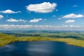 Aerial view of a lake formed at the base of green mountains Llyn y Fan Fach, Brecon Beacons, Wales